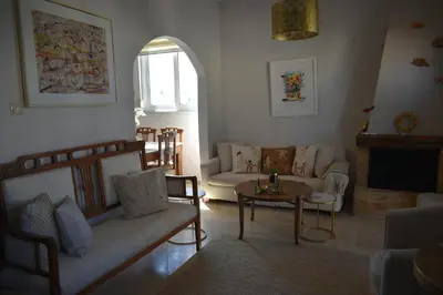 a living room with a couch and a table at Diotima - Astonishing seaview apartment in Chania Town