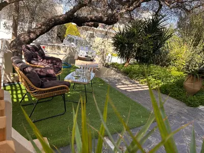 a patio with two chairs and a table in a yard at Elias Nest in Galatás