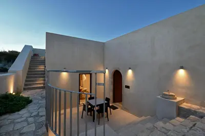 a patio of a house with a table and chairs at Evans Villas in Kissamos