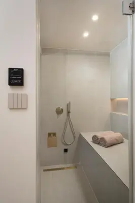 a white bathroom with a shower and a sink at Selected Suites in Chania Town