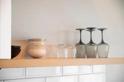 a shelf with glass vases and bowls on it at Elia Suites in Falasarna