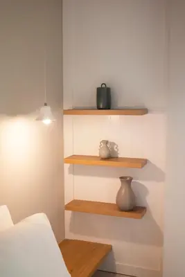 a room with wooden shelves and a bed at Elia Suites in Falasarna