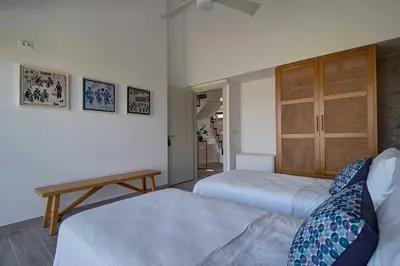 a hotel room with two beds and a table at Villa Simera, with pool & great view in Fournádhos
