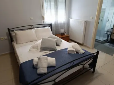 a bedroom with a bed with towels on it at Del's Apartment in Chania Town