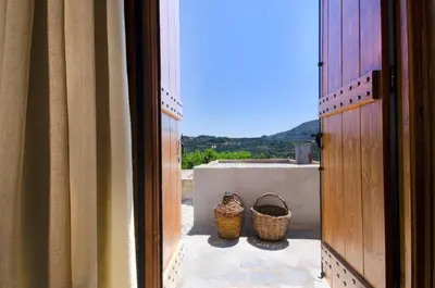two baskets are sitting on the porch of a house at Kallimento-Dimitra in Kissamos