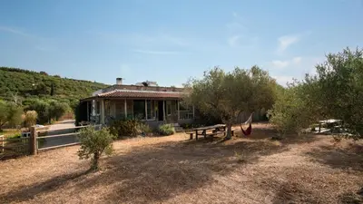 a house with a picnic table in front of it at WHITE MOUNTAINS Nature Home in Arménoi