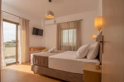 a hotel room with a bed and a balcony at Diktamo apartment, Palaiochora in Palaiochóra