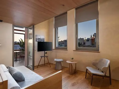a living room with a couch and some windows at Elysia Boutique Hotel in Chania Town