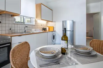a kitchen with a table with a bottle of wine at Urban Living City Apartment in Chania Town