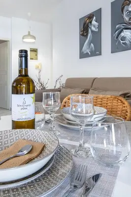 a bottle of wine sitting on top of a table at Urban Living City Apartment in Chania Town