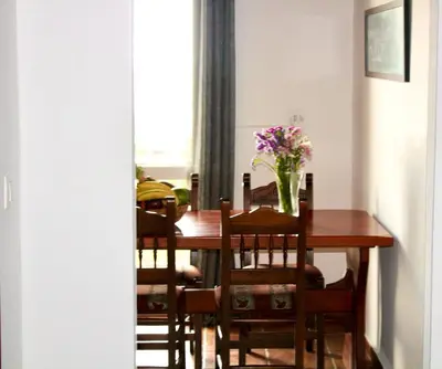 a dining room table with a vase of flowers on it at Sea Sight Vibes in Frangokastello