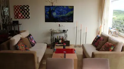 a living room with two couches and a table at Constantin in Dhémbla
