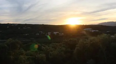 an image of the sun setting over a city at Constantin in Dhémbla