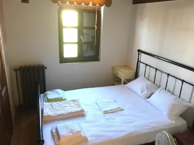 a bedroom with a bed with two towels on it at Luxurious Venetian 3 FLOOR HOUSE in the old port in Chania Town