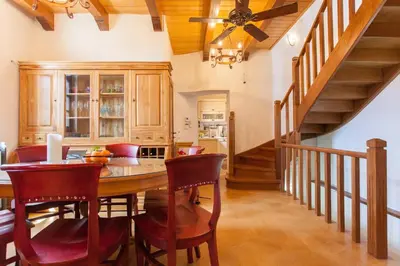 a kitchen with a table and chairs and a staircase at Luxurious Venetian 3 FLOOR HOUSE in the old port in Chania Town