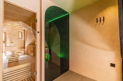 a bathroom with a shower with green lights on the wall at Mimosa Veneziano - Sauna - Old Town Chania in Chania Town