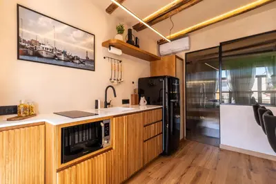 a kitchen with a sink and a refrigerator at Mimosa Veneziano - Sauna - Old Town Chania in Chania Town