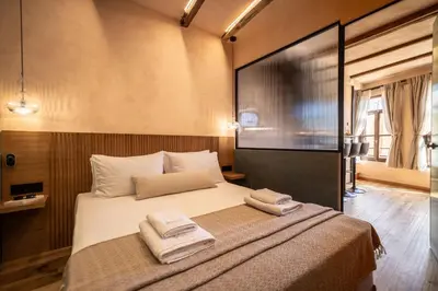 a bedroom with a bed with two towels on it at Mimosa Veneziano - Sauna - Old Town Chania in Chania Town