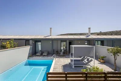 an exterior view of a house with a swimming pool at Natura Hill Villa II Sunset View in Kounoupidhianá