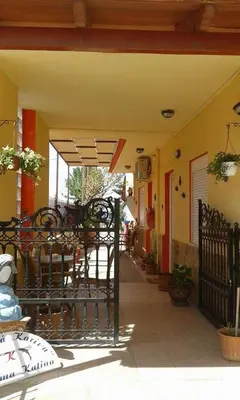 a patio with tables and chairs on a building at Gradma Katina in Plataniás