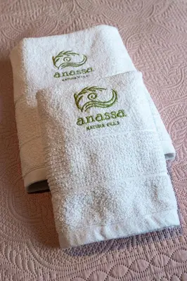 two towels sitting on top of a bed at Anassa Natura Villa in Daratso