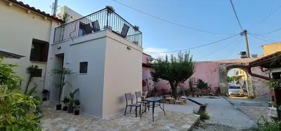 a patio with chairs and a table in a courtyard at Sappho 3-bedroom House in Daratso