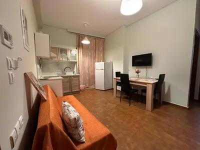 a room with a kitchen and a table with a dining room at Haris home 1 in Chania Town