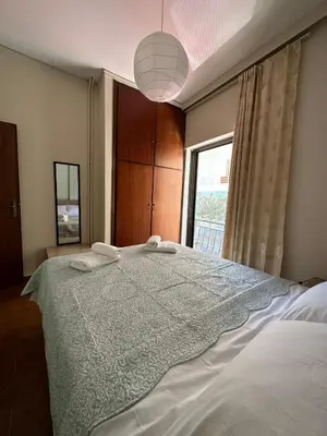 a bedroom with a large bed with a window at Haris home 1 in Chania Town