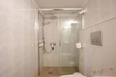 a bathroom with a glass shower with a toilet at Halases Panorama Villa pvt pool in Alikampos