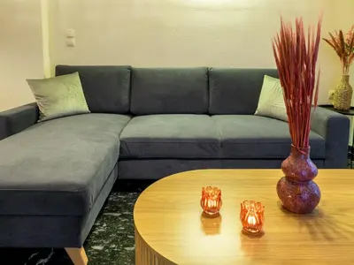a living room with a couch and a table at Atenà Urban Living in Chania Town