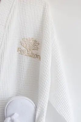 a white curtain with a gold insignia on it at Feli Living in Spiliá