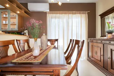 a dining room with a table and chairs with flowers on it at Casa BI LA in Galatás