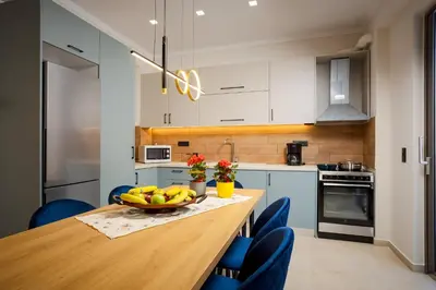 a kitchen with a wooden table with a bowl of fruit on it at Polixenys home in Daratso