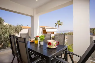 a table on the balcony with a cup of coffee at Polixenys home in Daratso