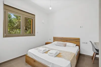 a bedroom with a bed and a window at AURA - Deluxe Apartment in Chania Town