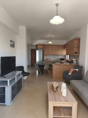 a living room with a couch and a table at Van Gogh & Monet apartments in Maleme