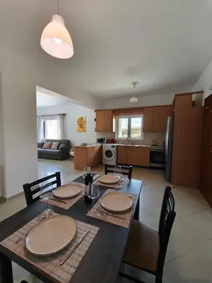 a kitchen and dining room with a table and chairs at Van Gogh & Monet apartments in Maleme