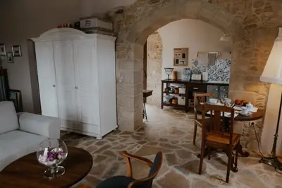 a living room with a couch and a table at Ewa's Cretan Vintage Houses in Kharkhalianá