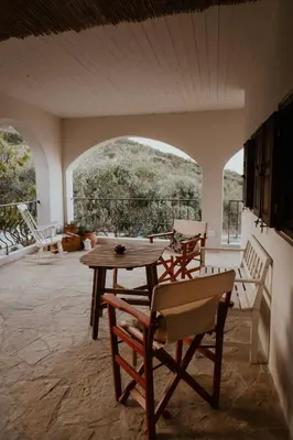 a dining room with a table and chairs in a room at Ewa's Cretan Vintage Houses in Kharkhalianá