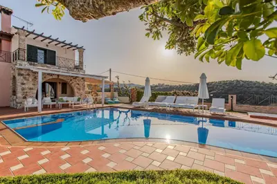 a swimming pool in front of a villa at Villa Trouli by Vintage Travel in Metókhi