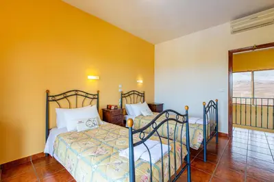 two beds in a room with yellow walls at Villa Trouli by Vintage Travel in Metókhi