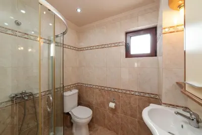 a bathroom with a toilet and a shower and a sink at Villa Halepi by PosarelliVillas in Gavalochori