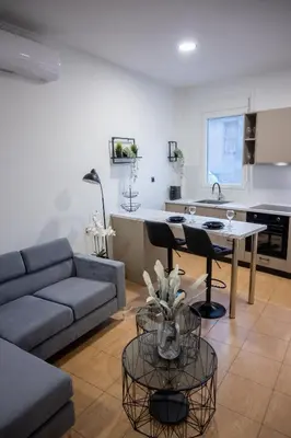 a living room with a couch and a table at Breezy Sea View Appartment in Chania Town