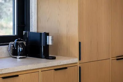 a coffee maker on a counter next to a window at Etheria Elli Villa, Retreat to Ethereal Luxury and Wellness by etouri in CHQ