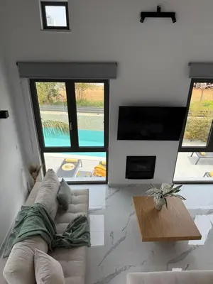 a living room with a couch and some windows at Galanakis luxury villa in Chania Town
