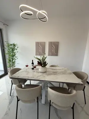 a dining room with a marble table and chairs at Galanakis luxury villa in Chania Town