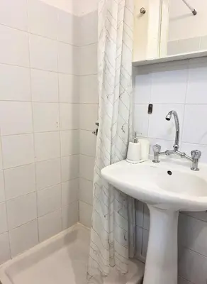 a bathroom with a sink and a shower curtain at Casa Kadanoleon old town with private terrace in Chania Town