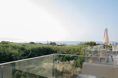 a glass balcony with a view of the ocean at Welcome U2 in Gerani Chanion