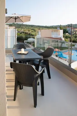 a table and chairs on a balcony with a view at Welcome U2 in Gerani Chanion