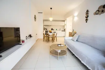 a living room with a couch and a table at Be Crete - Miramare apartment in Chania Town